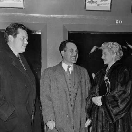 Orson Welles and Rita Hayworth pose with an Academy curator in the old Steinhart Aquarium.