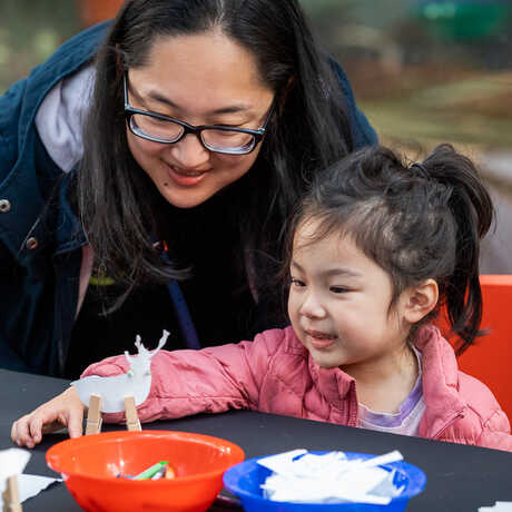 Woman and young girl enjoy making reindeer crafts at the Academy's 'Tis the Season for Science