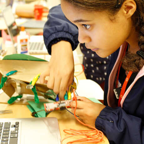 A girl programs an electronic puppet in an Academy after-school program