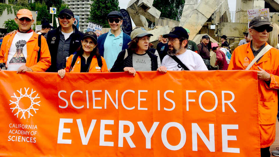 March for Science banner says "Science is for Everyone" held by Academy staff
